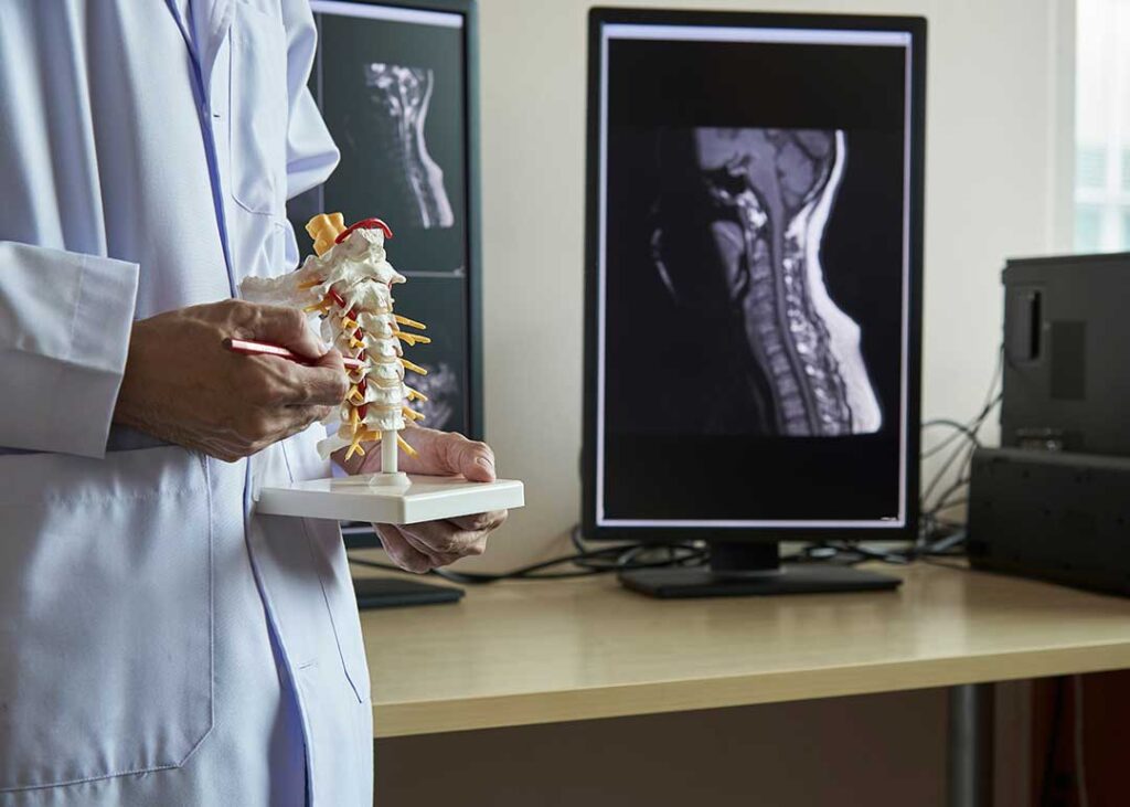 Patient discusses back pain with a chiropractor during a calm, professional health assessment.